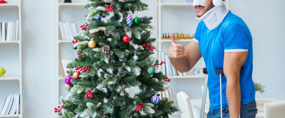 Man who just had an accident in front of the Christmas tree
